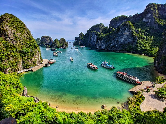 Halong Bay Junk Boat Tours: Complete Travel Guide for an Unforgettable Cruise Experience 6 Sunset view of multiple junk boats sailing through Halong Bay.