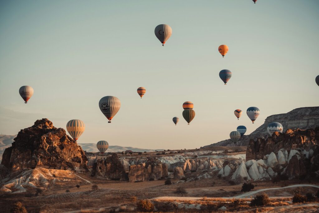 15 Most Beautiful Places in the World You Must Visit in 2026 6 Hot air balloons flying over Cappadocia at sunrise.